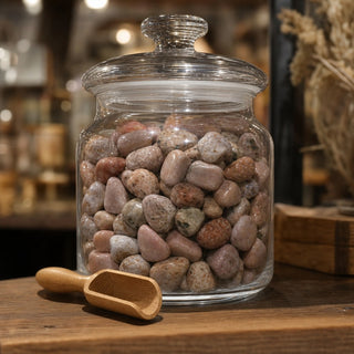 Pink Amethyst Tumbled Stones in a glass apothecary jar with a scoop