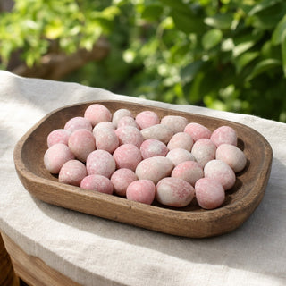 Pink Opal B Tumbled Stones in a wooden tray at a market stall