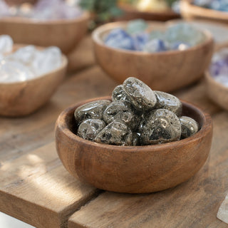 Pyrite Geode Tumbled Stones - Peru in a wooden bowl on a boutique display table