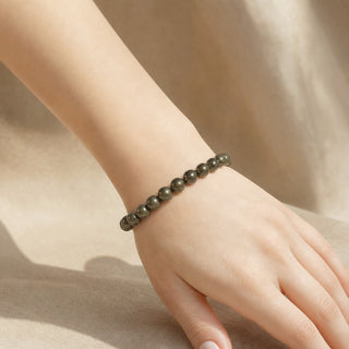 Pyrite bead bracelet worn on the wrist, close-up