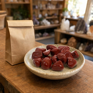 Red Jasper Tumbled Stones - Brazil in a ceramic bowl on a shop counter