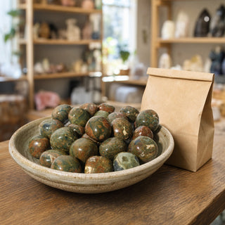 Rhyolite Tumbled Stones in a ceramic bowl on a shop counter