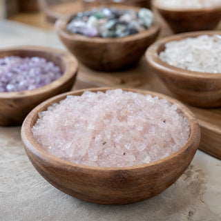 Rose Quartz B Tumbled Stones - Assorted Tiny in a wooden bowl on a boutique display table
