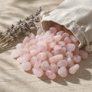 Rose Quartz B Tumbled Stones spilling from a linen pouch