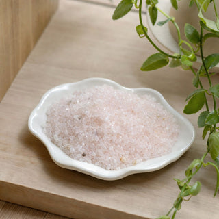 Rose Quartz B Tumbled Stones - Tiny in a stoneware dish on a shop shelf