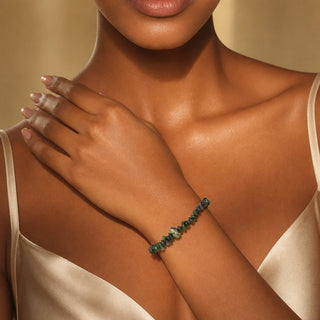 Ruby Zoisite bead bracelet worn with the hand resting on the chest