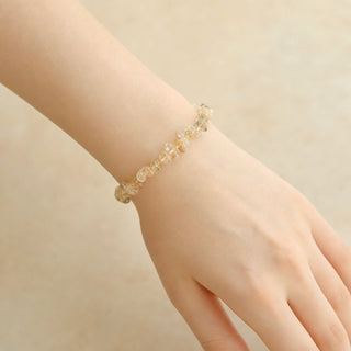Rutilated Quartz bead bracelet worn on the wrist, close-up