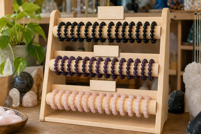 Bead bracelets displayed in rows by colour