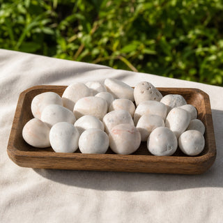 Scolecite Tumbled Stones - India in a wooden tray at a market stall