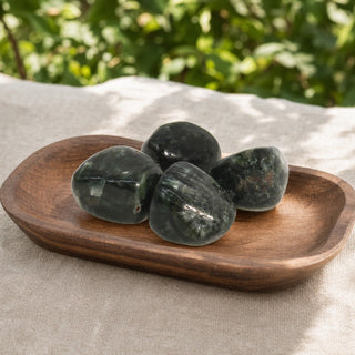 Seraphinite A Tumbled Stones in a wooden tray at a market stall
