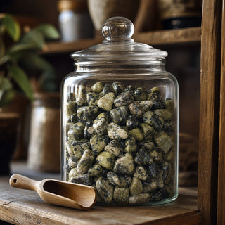 Serpentine Tumbled Stones - Brazil in a glass apothecary jar with a scoop
