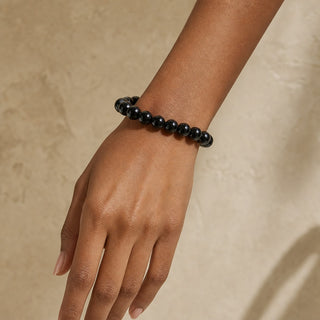 Shungite bead bracelet worn on the wrist, close-up