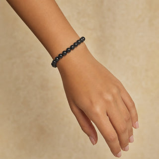 Shungite bead bracelet worn on the wrist, close-up