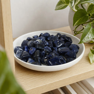 Sodalite A Tumbled Stones - Brazil in a stoneware dish on a shop shelf