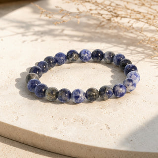 Sodalite bead bracelet resting on a stone slab