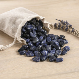 Sodalite E Tumbled Stones - Brazil spilling from a linen pouch