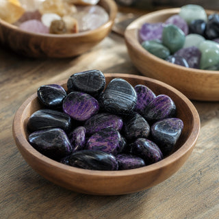 Sugilite E Tumbled #2 in a wooden bowl on a boutique display table