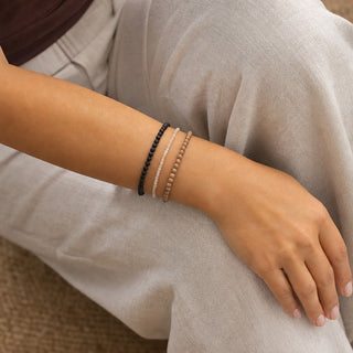 Sunstone bead bracelet stacked with other bead bracelets on the wrist