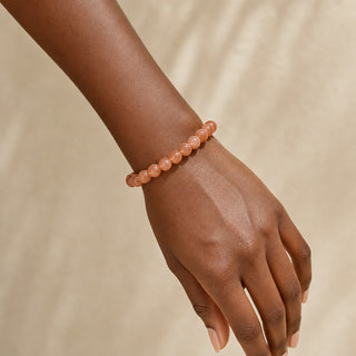 Sunstone bead bracelet worn on the wrist, close-up