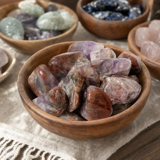 Super 7 Tumbled Stones in a wooden bowl on a boutique display table