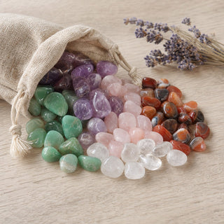 The Tumbled Stones Essentials - Bundle spilling from a linen pouch