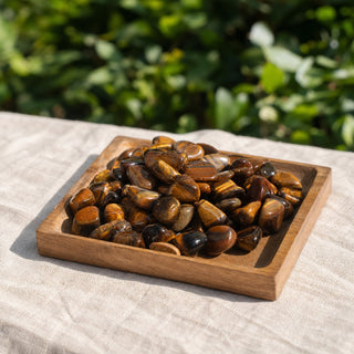 Tiger Eye Gold Tumbled Stones - Brazil in a wooden tray at a market stall