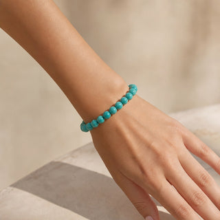 Turquoise bead bracelet worn on the wrist, close-up