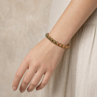 Unakite bead bracelet worn on the wrist, close-up