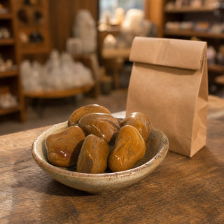Yellow Jasper Tumbled Stones in a ceramic bowl on a shop counter