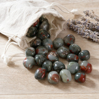 African Bloodstone Tumbled Stone spilling from a linen pouch
