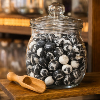 Zebra Jasper Tumbled Stones in a glass apothecary jar with a scoop